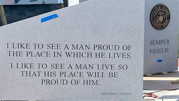 Close up of Abraham Limncoln quote with Marine Corps pilon in the background