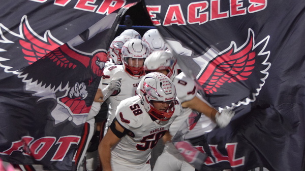 DASD Football team busting through eagles banner