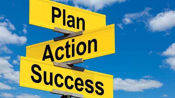 Road sign pointing in different directions that says Plan, Action, and Success