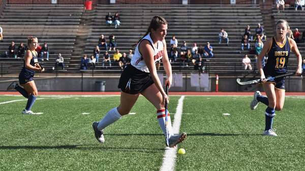 Dover field hockey player in action