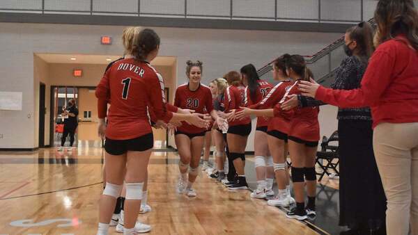 High school team with player running down high fiving