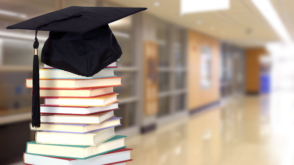 Graduation cap on top of books.