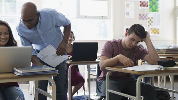 Teacher working with high school age students