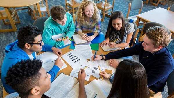 Top-down view of high school students working at a table