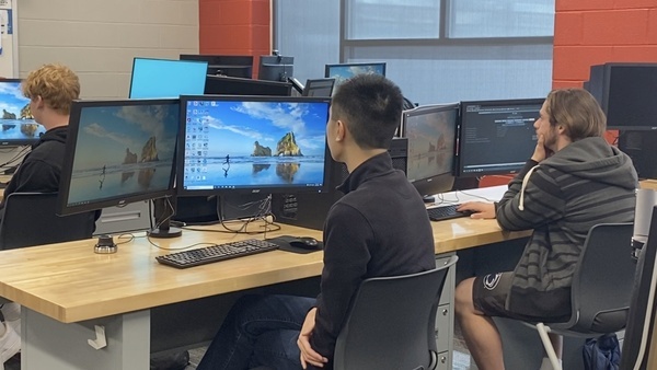 Students  sitting behind computers in engineering course