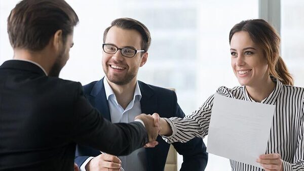 People dressed professionally shaking hands