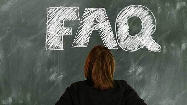 Chalkboard with FAQ written and back of person's head looking at it.