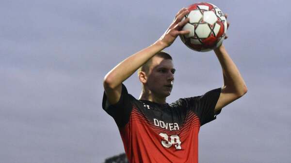 Dover player holding the ball above his head