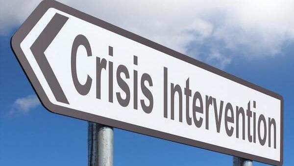 road sign that reads crisis intervention