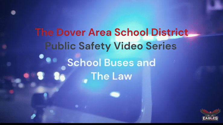 Police car with flashing lights. Text says The Dover Area School District Public Safety Video Series: School Buses and the Law.
