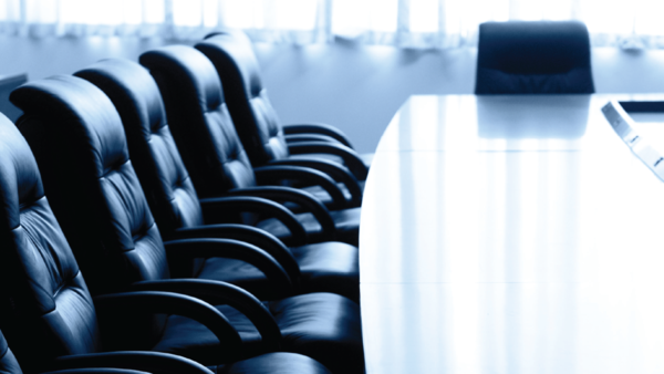 empty board room with focus on nearby chairs